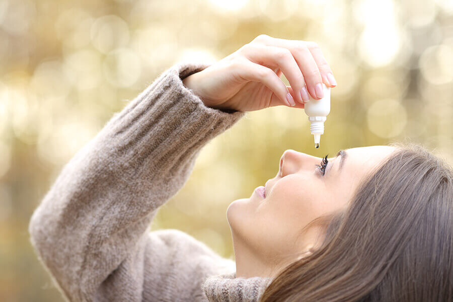 Woman using eye drops for dry eye